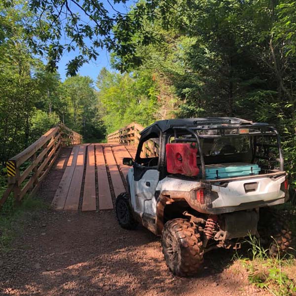 4 person ATV on a trail bridge